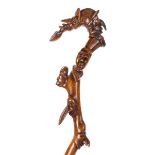 *Walking Cane. A 19th century Folk Art carved crooked wood cane, intricately carved from a single