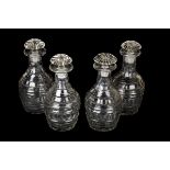 *Decanters. A set of four George III glass decanters, each of mallet form with slice cut decoration,