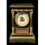 *Clock. A French brass mantel clock, c.1850, the brass case with circular white enamel dial, black