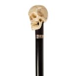 *Walking Cane. A 19th century walking stick, with finely carved ivory skull on an ebony shaft with
