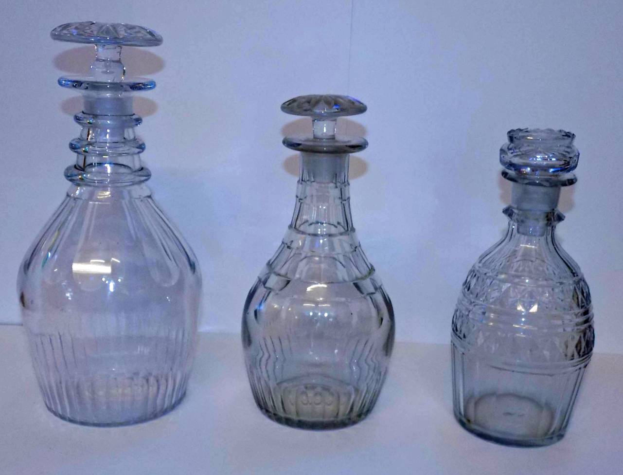 *Decanters. A mixed collection of Georgian glass decanters, including triple neck decanters (three