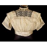 *Clothing. A late Victorian cream chiffon bodice, hand-stitched, short-sleeved, high-necked boned