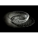 *Bowl. A George III Irish glass circular bowl, circa 1800, finely cut with stars and wavy rim,
