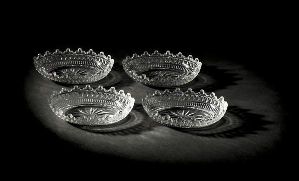 *Dishes. A set of four George III small epergn‚ dishes, circa 1800, the body cut with a band of