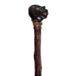 *Walking Cane. A 19th century Folk Art Anti-Slavery walking stick, the handle carved with an African