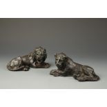 A PAIR OF CAST IRON MODELS OF RECUMBENT LIONS, late 19th century, 7.5" and 7"