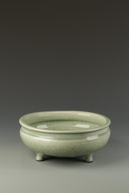 A CHINESE LONGQUAN CELADON TRIPOD CENSER, the rounded body with cross-hatched decoration, Ming, 11.