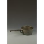 A BRONZE SKILLET TYPE PAN with circular bowl and extended handle, possibly 17th century, 19"