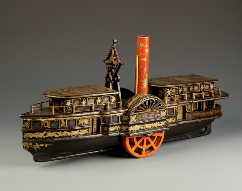 A CHINESE EXPORT LACQUER MODEL PADDLE STEAMER with central red funnel flanked by twin lidded