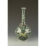 A LARGE CHINESE FAMILLE VERTE BOTTLE VASE with a relief dragon on the shoulder and all over prunus