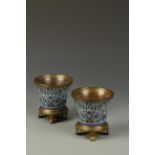 A PAIR OF CHAMPLEVE ENAMEL CACHEPOT of flared form with European stands, 19th century, 5" high (2)