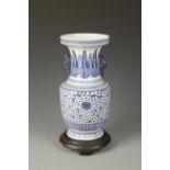 A LARGE CHINESE BLUE AND WHITE BALUSTER VASE with dragon handles, the body decorated with flowers