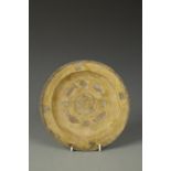 A CHINESE SANCAI TRIPOD DISH, the centre decorated with fish surrounding a flowerhead, Tang, 8"