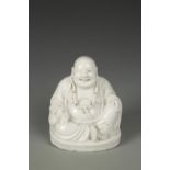 A CHINESE BLANC-DE-CHINE BUDAI, the Immortal seated with one knee raised, late Qing-Republic, 6"