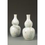 A PAIR OF CHINESE DOUBLE-GOURD VASES enamelled with scholars in a rocky landscape and calligraphy,