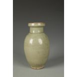 A CHINESE LONGQUAN CELADON OVOID VASE carved with a central band of stylised flowers between