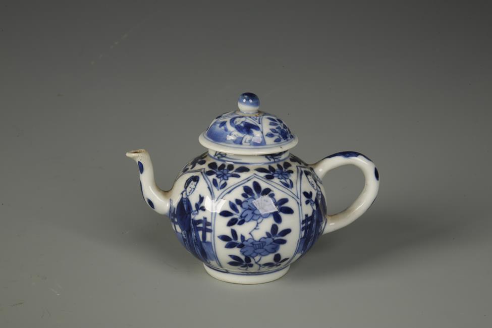 A CHINESE BLUE AND WHITE MINIATURE EWER decorated with alternating panels of figures and flowers,