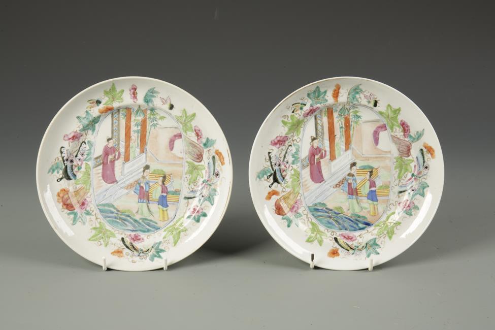 A PAIR OF CHINESE FAMILLE ROSE SAUCER DISHES decorated with panels of figures within butterfly and