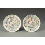 A PAIR OF CHINESE FAMILLE ROSE SAUCER DISHES decorated with panels of figures within butterfly and