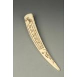 A SCRIMSHAW WALRUS TUSK worked to one side with a cribbage board, the reverse decorated with