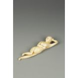 A CHINESE IVORY FEMALE NUDE, the reclining figure with one arm across the chest, Qing, 18th/19th