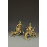 A PAIR OF GILT METAL ROCOCO STYLE CHENETS, each mounted with a figure on a scrolling base, 19th