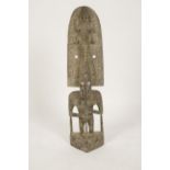 PAPUA NEW GUINEA: A standing figure with cowry eyes wearing an elaborate head dress carved with a