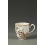 A WORCESTER COFFEE CUP painted in the Chinese famille rose style with figures at at a table in a