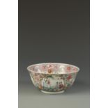 A CHINESE FAMILLE ROSE BOWL decorated with landscape roundels on a dense foliate ground, the base