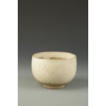 A CHINESE CIZHOU DEEP BOWL covered in a creamy glaze, Northern Song-Yuan, 5.5" dia.