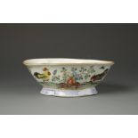 A CHINESE FAMILLE ROSE QUATREFOIL BOWL decorated with cockerels in a landscape, late Qing, 7.5"