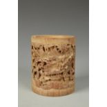 A CHINESE BAMBOO BRUSHPOT carved with figures in a mountain wood landscape, late Qing-early