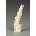 A CHINESE IVORY SPILL VASE of slender form carved with peacocks and prunus, late Qing (late 19th-