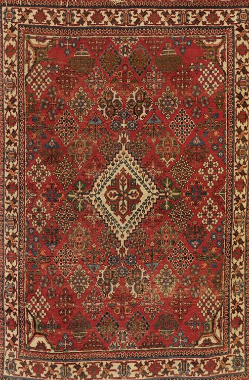 A SMALL NORTH WEST PERSIAN RUG, the brick red ground with a central ivory stepped medallion on a