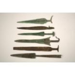 FOUR ANCIENT ASIATIC BRONZE SHORT SWORDS AND TWO SPEARHEADS