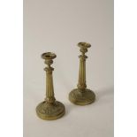 A PAIR OF GILT METAL EMPIRE STYLE CANDLESTICKS