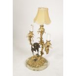 A PATINATED AND GILT BRONZE THREE BRANCH TABLE LAMP