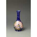 A MOORCROFT VASE with pink flowers on a blue ground