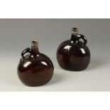 A PAIR OF SILVER MOUNTED AMBER GLASS FLASKS