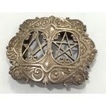 A SILVER MASONIC BUCKLE, with pierced and scroll decoration, 3" x 3.5".