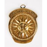 A GEORGE III SILVER-GILT SUN FIRE OFFICE FIREMAN'S ARM BADGE, shaped circular with a central sun