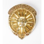 A GEORGE III SILVER-GILT SUN FIRE OFFICE FIREMAN'S ARM BADGE, shaped circular with a central sun