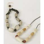 A STRING OF THIRTEEN "CHICKEN BONE" JADE AND HARDSTONE BEADS, Chinese antique, mainly of barrel