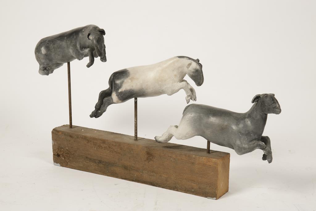 TANYA BRETT (b.1974), 'Leaping Sheep', three ceramic sheep in various jumping poses on a wooden base