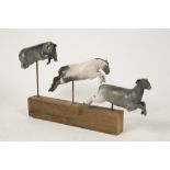TANYA BRETT (b.1974), 'Leaping Sheep', three ceramic sheep in various jumping poses on a wooden base