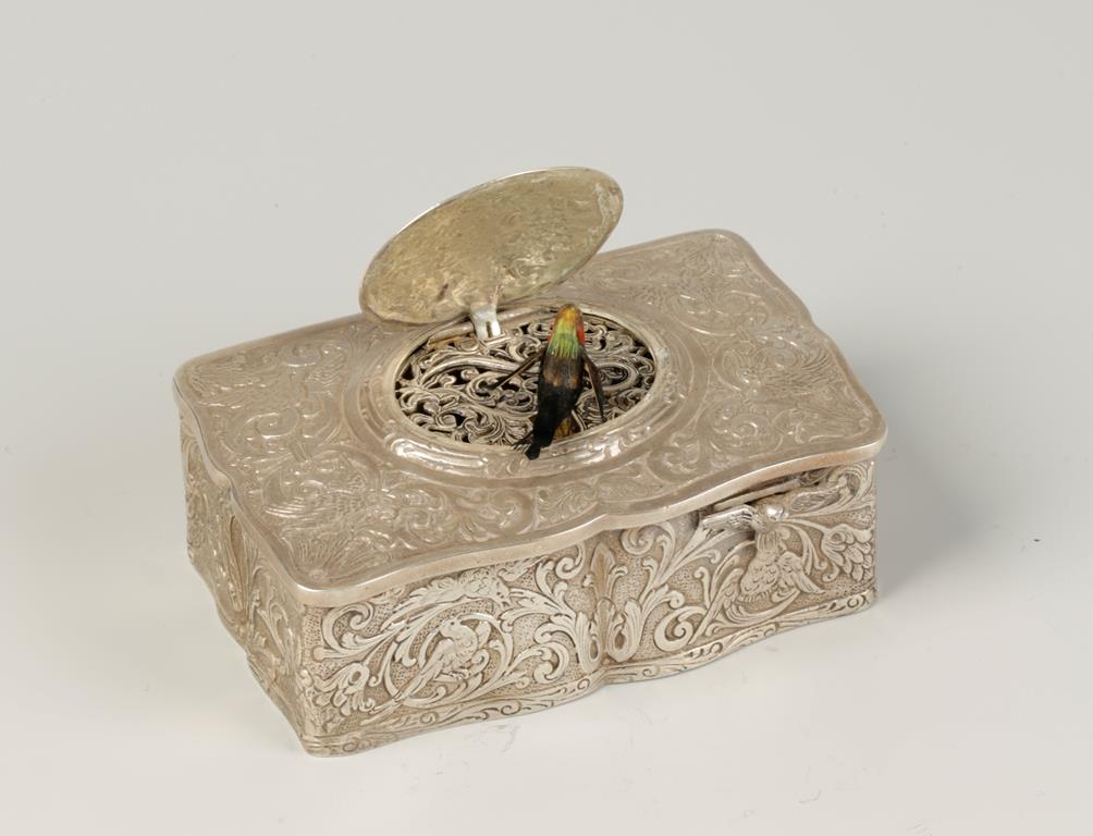 A GERMAN SILVER BIRD AUTOMATON MUSICAL BOX, in the manner of Karl Griersbaum, decorated with scrolls