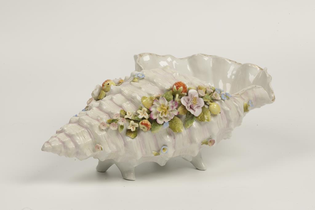 A 19TH CENTURY GERMAN PORCELAIN VASE in the form of a large floral encruster seashell, 14" wide