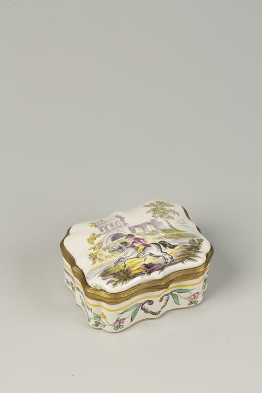 A CONTINENTAL ENAMELLED TABLE SNUFF BOX, of cartouche form, enamelled in polychrome against a