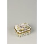 A CONTINENTAL ENAMELLED TABLE SNUFF BOX, of cartouche form, enamelled in polychrome against a