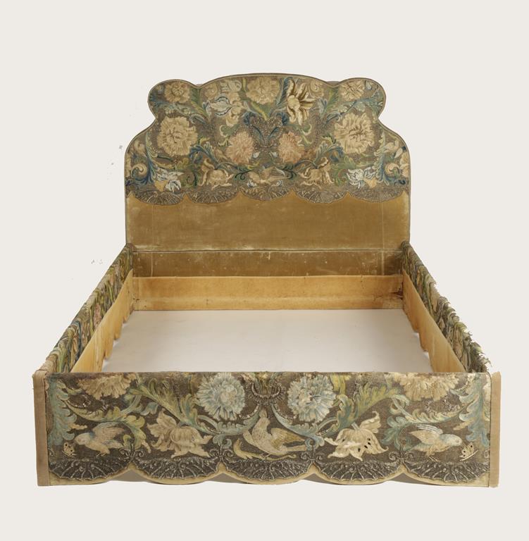 A VENETIAN 'SILKWORK' BED, the bed with a raised headboard with scrolling outline mounted with